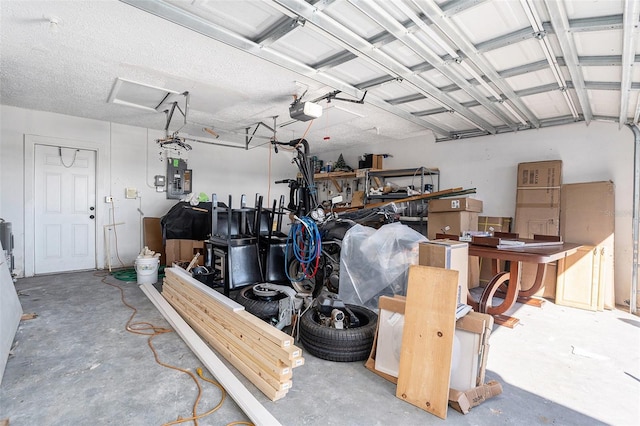 garage with a garage door opener and electric panel