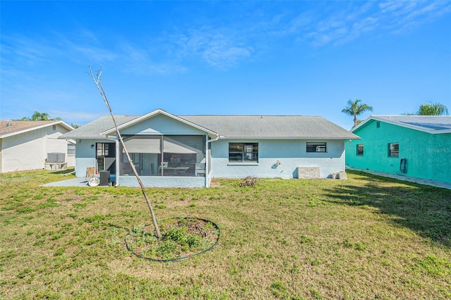 rear view of property featuring a sunroom, cooling unit, and a lawn