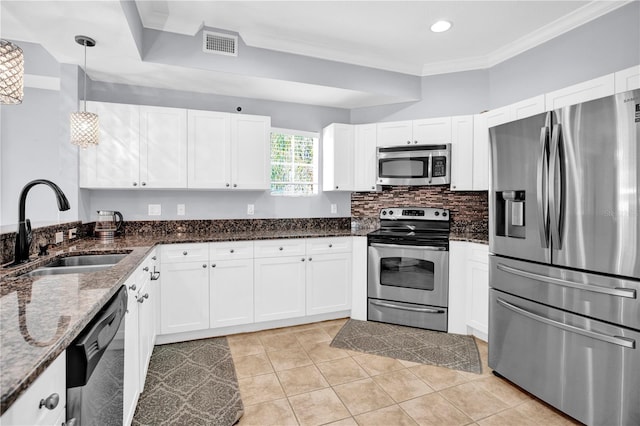 kitchen with white cabinets, pendant lighting, stainless steel appliances, and a sink