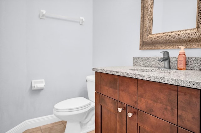 bathroom with baseboards, vanity, toilet, and tile patterned floors