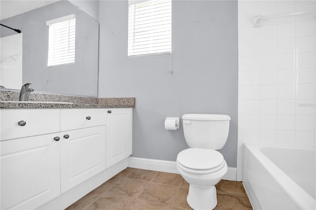 bathroom with baseboards, toilet, tile patterned flooring, vanity, and shower / washtub combination