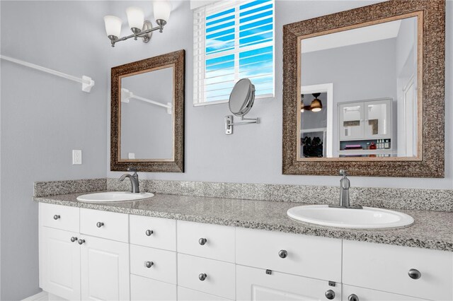 bathroom featuring a sink and double vanity