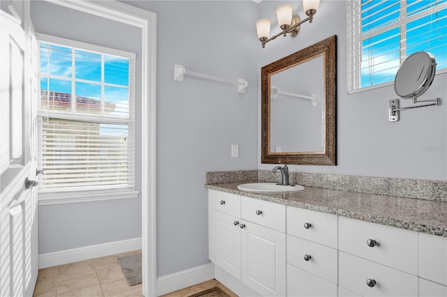 bathroom featuring tile patterned flooring, vanity, and baseboards