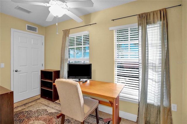 office space featuring ceiling fan and visible vents