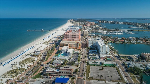 aerial view featuring a water view, a view of city, and a beach view