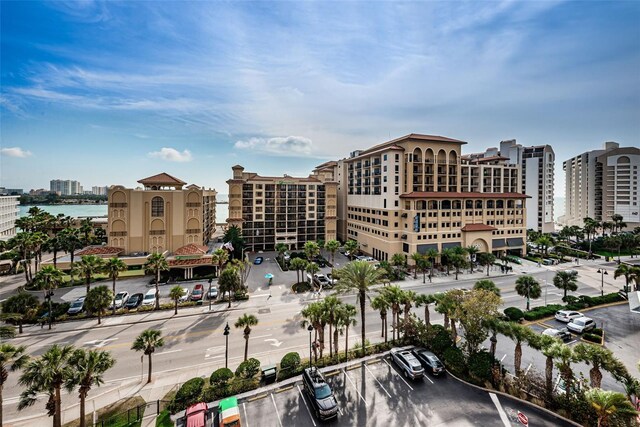 view of building exterior featuring uncovered parking and a city view