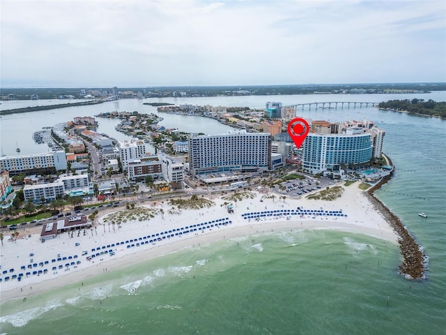 drone / aerial view featuring a beach view and a water view