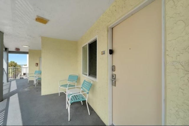 exterior space with a balcony and stucco siding