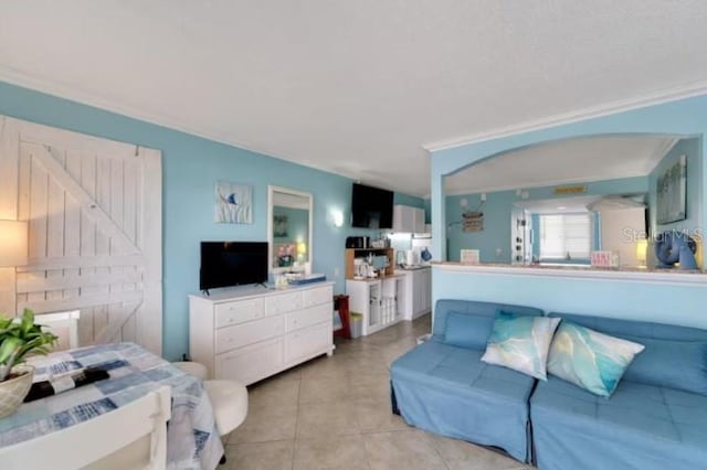 living area featuring light tile patterned flooring and crown molding