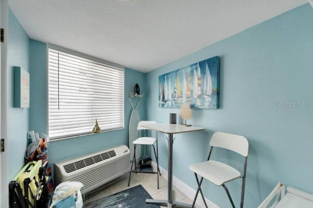 office area with a wall unit AC and tile patterned floors
