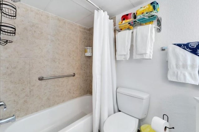 bathroom with shower / tub combo and toilet