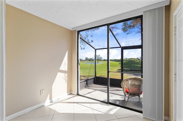 2073 Skimmer Ct W Unit 211, Clearwater, FL 33762 - entryway featuring a wall of windows, baseboards, a textured ceiling, and a healthy amount of sunlight