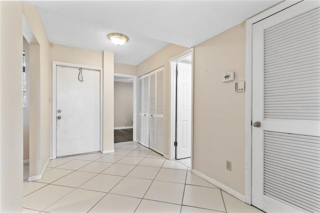 2073 Skimmer Ct W Unit 211, Clearwater, FL 33762 - corridor with baseboards and a textured ceiling