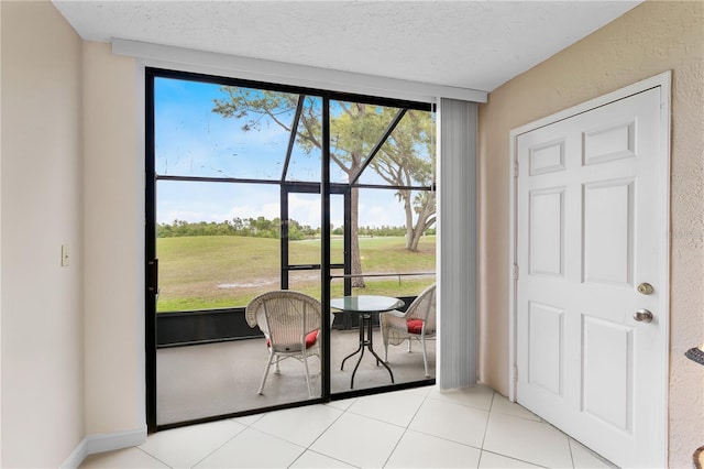 2073 Skimmer Ct W Unit 211, Clearwater, FL 33762 - entryway with tile patterned flooring, a textured ceiling, and golf course view