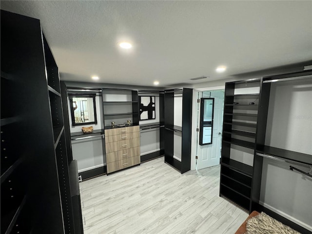 walk in closet with light wood-style floors and visible vents