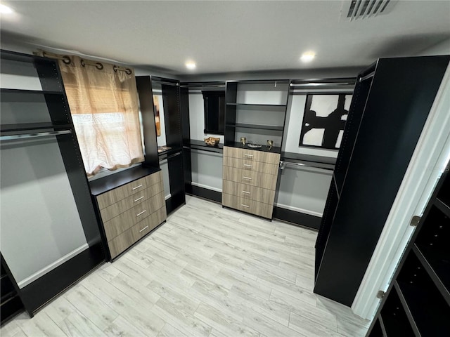 kitchen featuring recessed lighting, visible vents, baseboards, light wood-style floors, and freestanding refrigerator