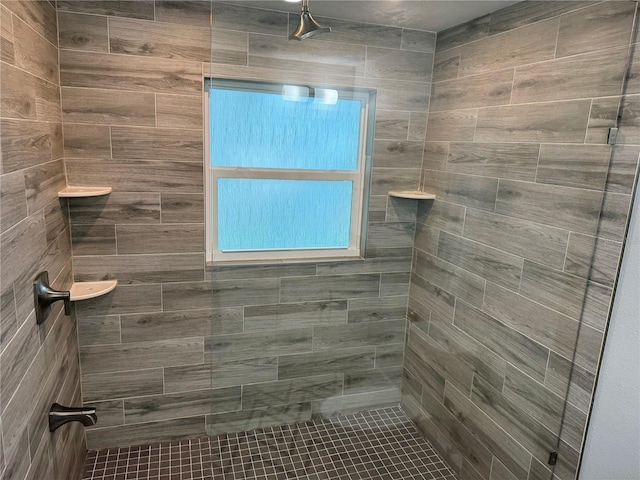 bathroom featuring a tile shower