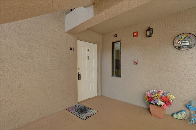 doorway to property with stucco siding