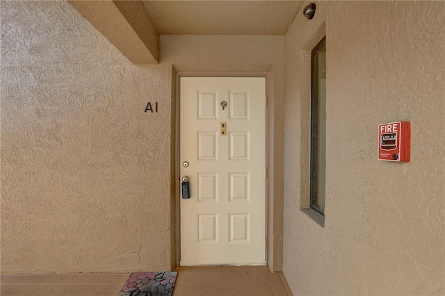 property entrance featuring stucco siding