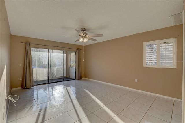 unfurnished room with ceiling fan, baseboards, and light tile patterned floors