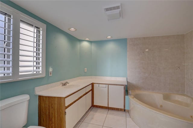 full bath with recessed lighting, toilet, vanity, tile patterned flooring, and a jetted tub