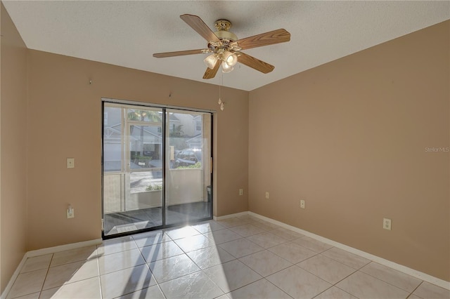 unfurnished room featuring a ceiling fan, light tile patterned flooring, a textured ceiling, and baseboards