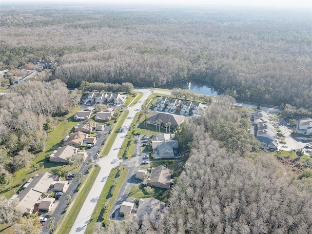 drone / aerial view featuring a residential view and a view of trees