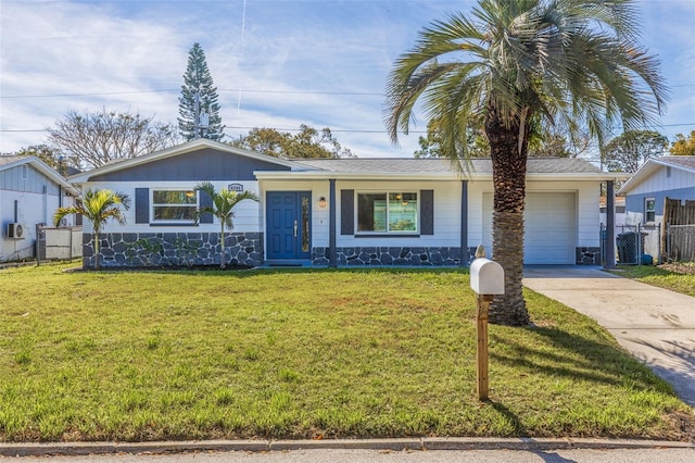 single story home featuring an attached garage, fence, driveway, a front lawn, and board and batten siding