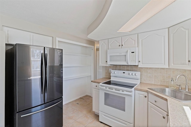 kitchen featuring tasteful backsplash, white appliances, white cabinetry, and a sink