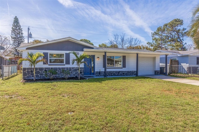 ranch-style home featuring an attached garage, fence, concrete driveway, and a front yard