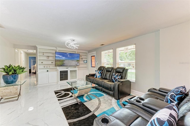 living area featuring built in shelves, marble finish floor, visible vents, and baseboards