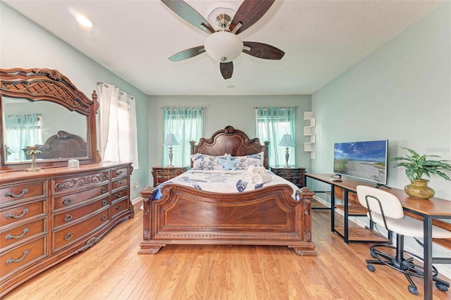 bedroom with a ceiling fan and light wood-style floors