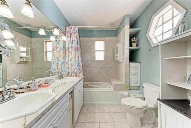 bathroom featuring toilet, a wealth of natural light, a sink, and tile patterned floors