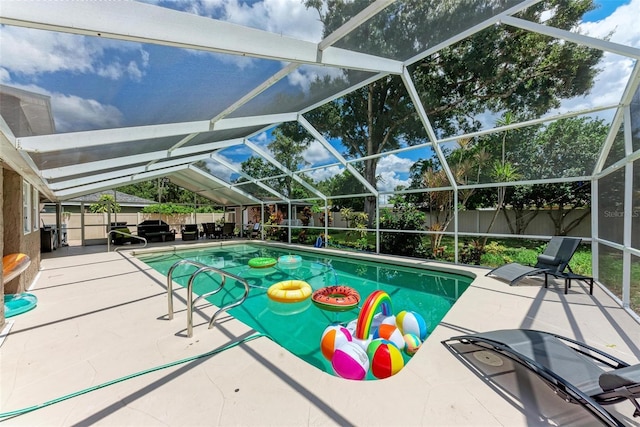 view of pool with a lanai, a patio area, a fenced backyard, and a fenced in pool