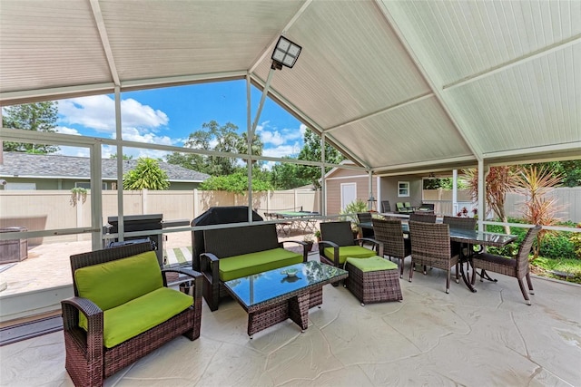 sunroom featuring lofted ceiling