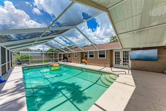 view of pool featuring a fenced in pool, a patio, a lanai, fence, and french doors