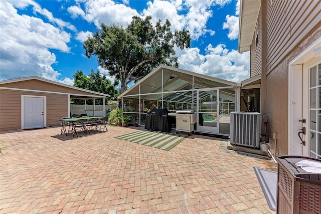 view of patio / terrace with glass enclosure, outdoor dining space, cooling unit, and a grill