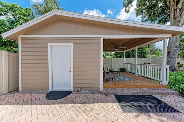 view of outbuilding featuring fence and an outdoor structure