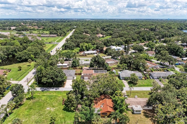 birds eye view of property with a residential view and a wooded view