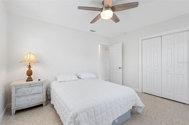 bedroom with light speckled floor, a closet, visible vents, and baseboards