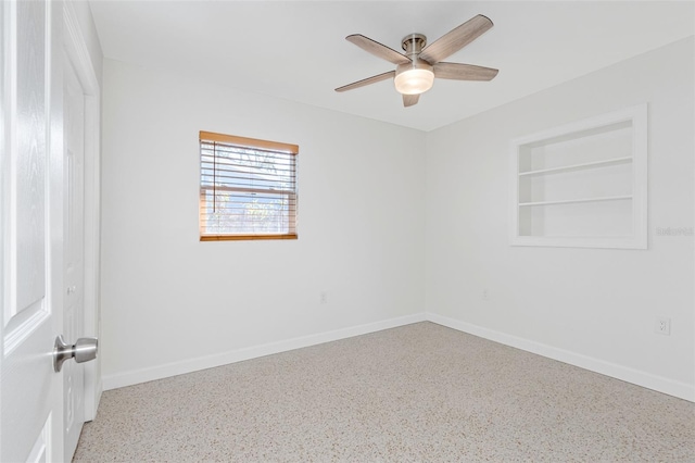 unfurnished room with ceiling fan, built in features, and baseboards