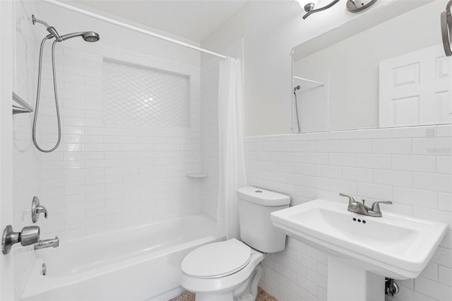 full bathroom with toilet, shower / tub combo, a sink, tile walls, and tasteful backsplash