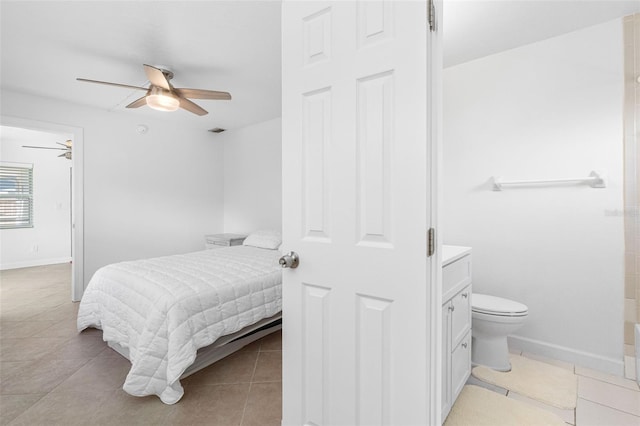 bedroom featuring visible vents, light tile patterned flooring, connected bathroom, ceiling fan, and baseboards