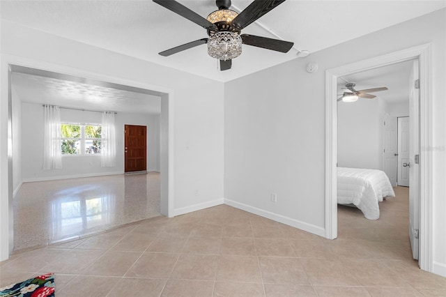 unfurnished room featuring light tile patterned floors and baseboards