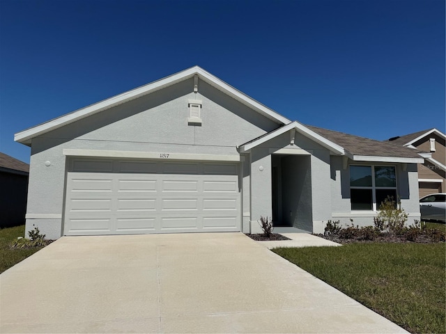 single story home with a shingled roof, an attached garage, driveway, and stucco siding