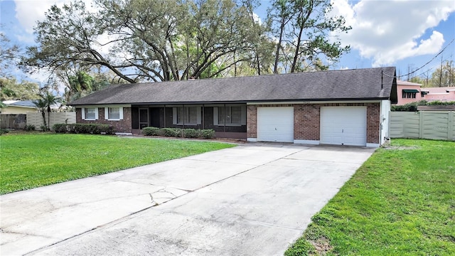 ranch-style home featuring driveway, brick siding, an attached garage, fence, and a front yard