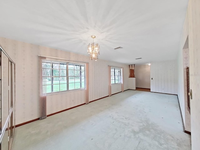 spare room with visible vents, baseboards, and wallpapered walls