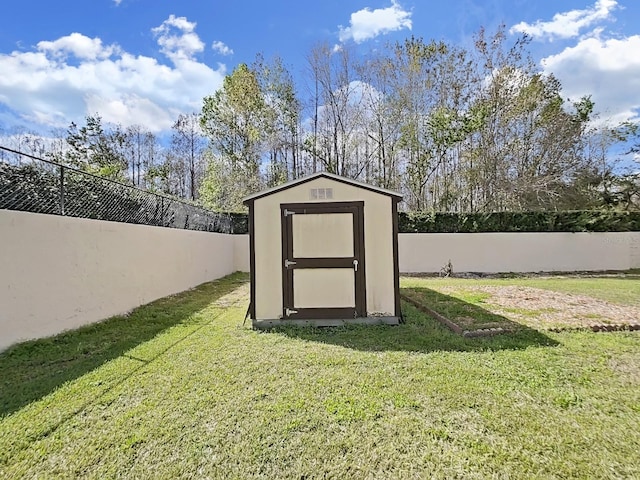 view of shed with a fenced backyard