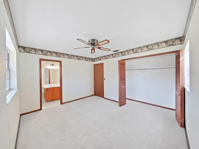 unfurnished bedroom with visible vents, baseboards, light colored carpet, ceiling fan, and a closet