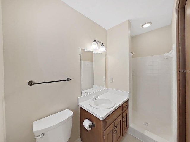 full bathroom with a stall shower, vanity, and toilet